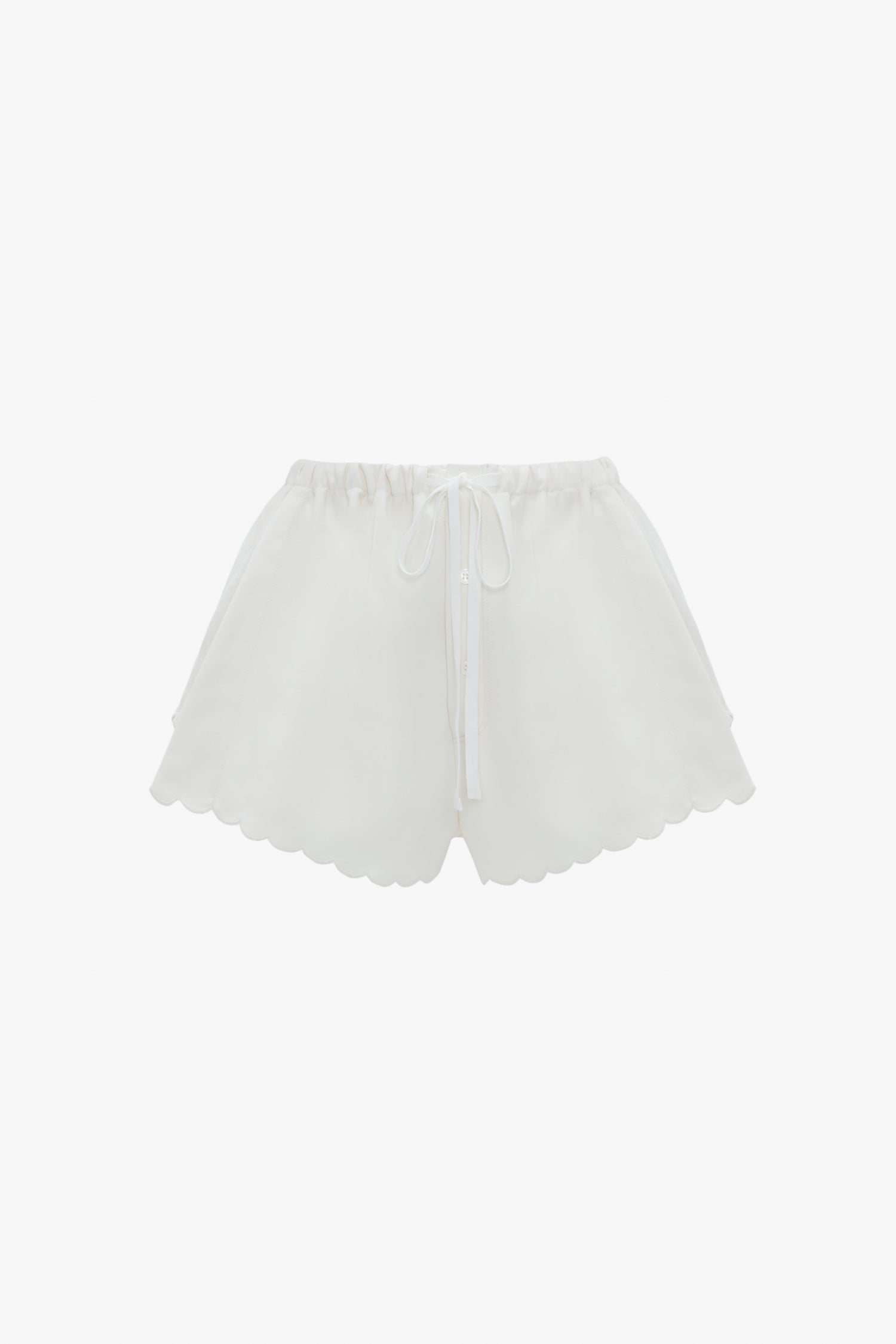 Drawstring Embroidered Mini Short In Antique White by Victoria Beckham, crafted from an antique white linen-cotton blend, feature an elastic waistband and drawstring tie, accented with delicate embroidered detailing. Displayed against a white background.