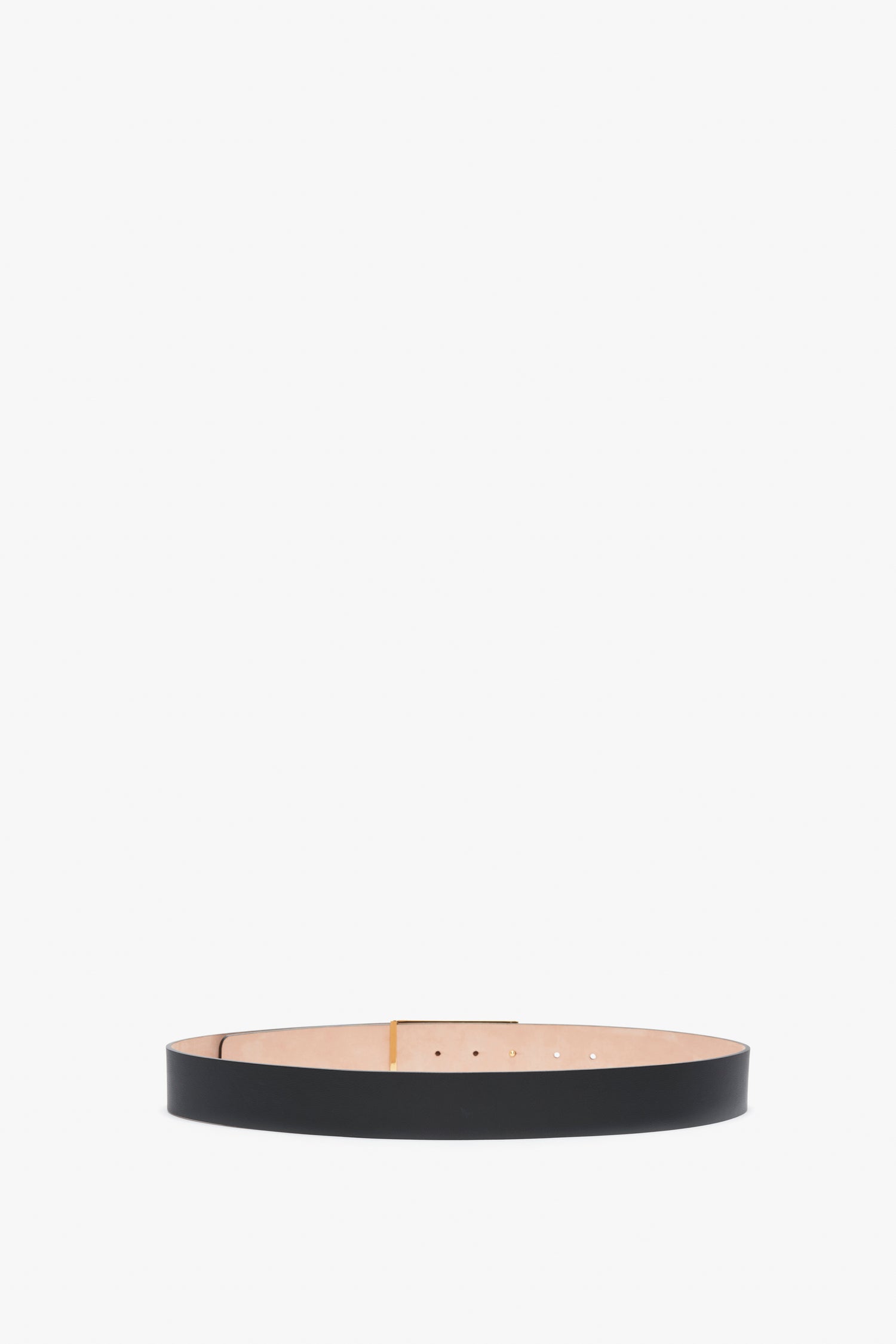 A navy Exclusive Jumbo Frame Belt In Navy Leather, crafted from smooth calf leather and featuring gold hardware by Victoria Beckham, is displayed against a plain white background.