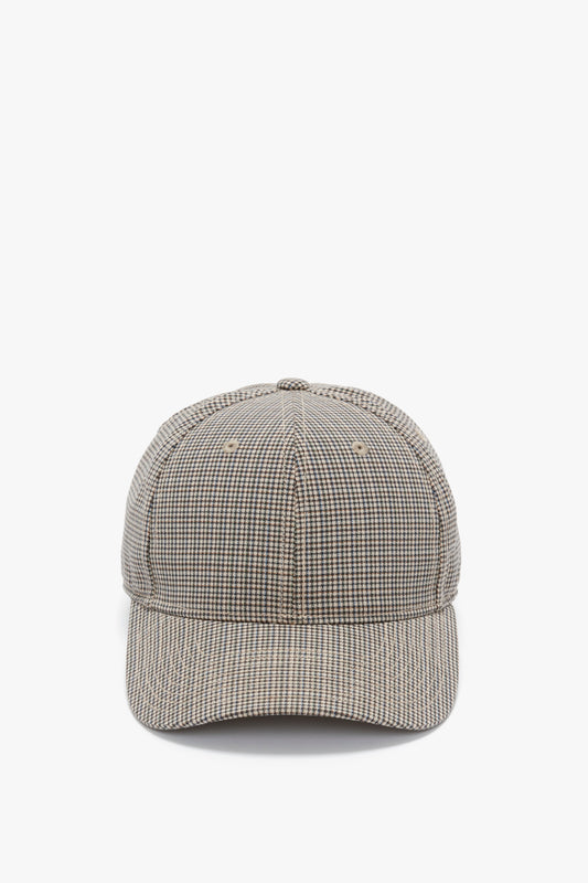 A front view of a Victoria Beckham Logo Cap In Dogtooth Check with a curved brim, isolated on a white background.