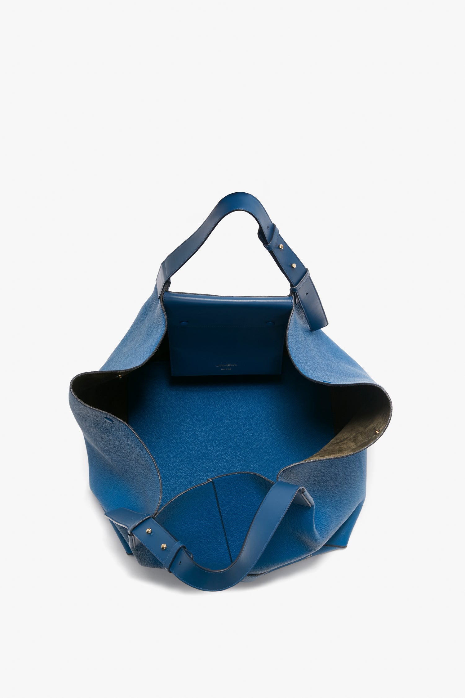 Open the Victoria Beckham W11 Medium Tote Bag in vibrant blue leather with structured top handles, a small interior pocket, and adjustable straps.