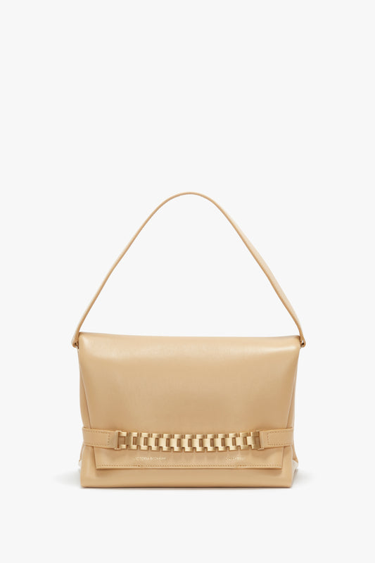 A Victoria Beckham Chain Pouch Bag With Strap In Sesame Leather with a single top handle and a woven design across the front. The bag has a minimalist style with no visible adornments or logos, featuring a subtle gold chain detail for added elegance.