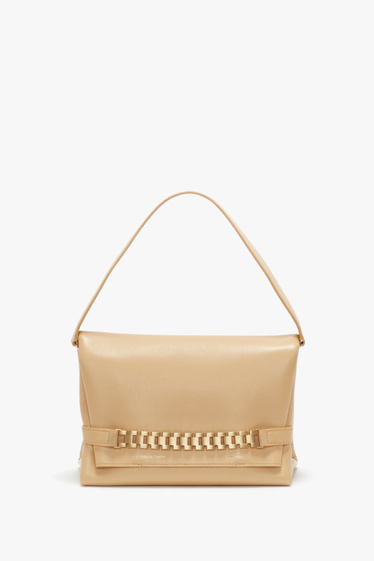 Sesame leather chain pouch with a prominent chain detail on the base, standing upright against a plain white background by Victoria Beckham.