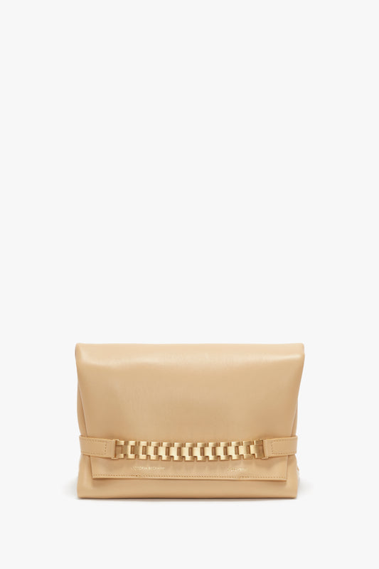 A beige, rectangular Chain Pouch Bag With Strap In Sesame Leather by Victoria Beckham with a woven detail on the front, a fold-over design, and a gold chain detail adds a touch of elegance.