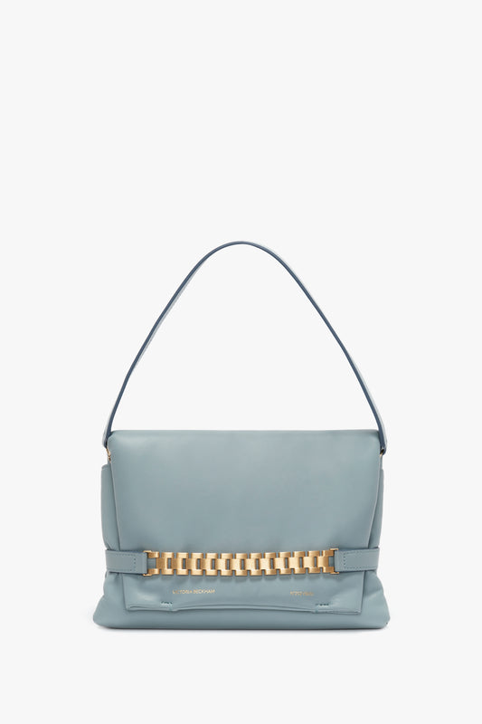 A pale blue Victoria Beckham nappa leather handbag featuring a single handle and a decorative signature gold chain across the front, displayed against a white background.