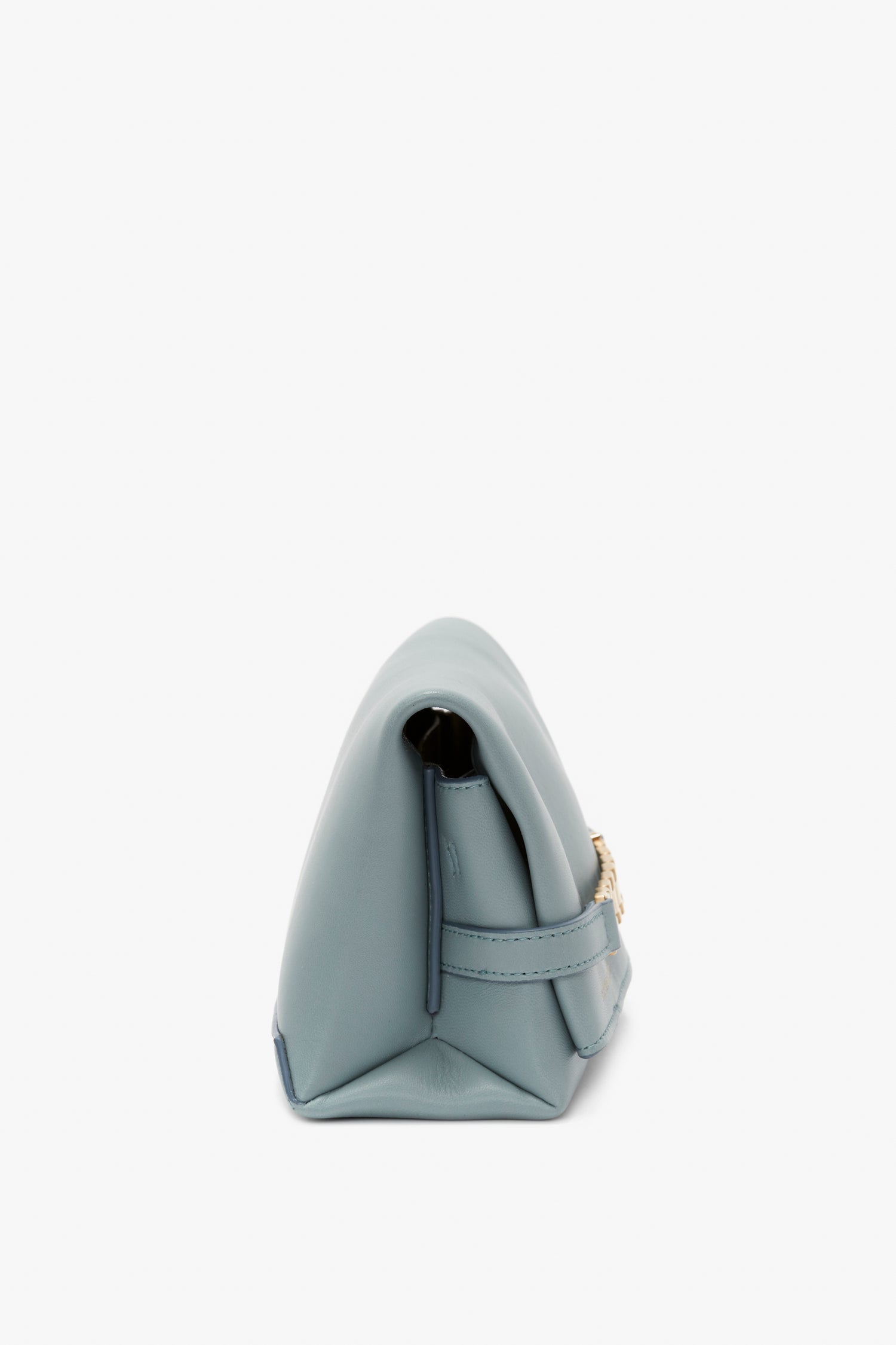 Side view of a small light blue Victoria Beckham Mini Chain Pouch Bag With Long Strap In Ice Leather with a visible gold-tone chain strap.