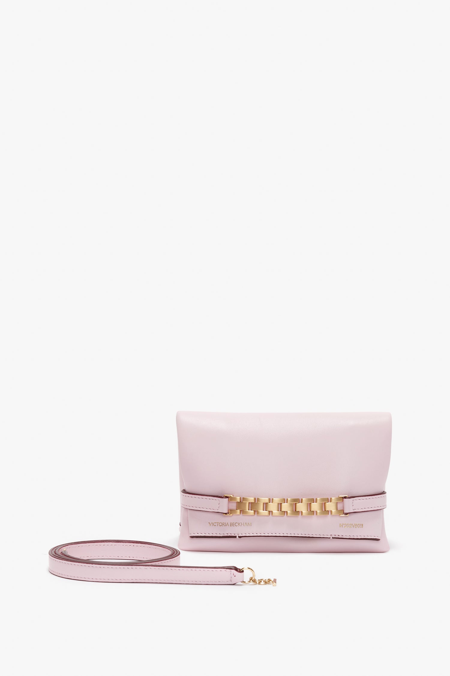 A Victoria Beckham Mini Chain Pouch Bag With Long Strap In Orchid Leather, this versatile mini pouch can be elegantly worn as a crossbody bag, positioned on a white background.
