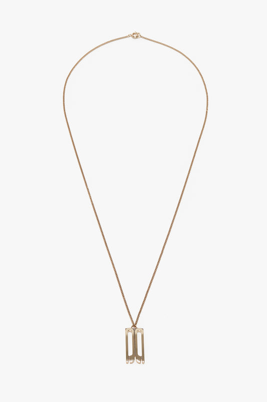 An Exclusive Frame Necklace In Gold by Victoria Beckham with a thin chain and a pendant featuring two vertical rectangular shapes linked together, echoing the elegant simplicity found in Victoria Beckham accessories.