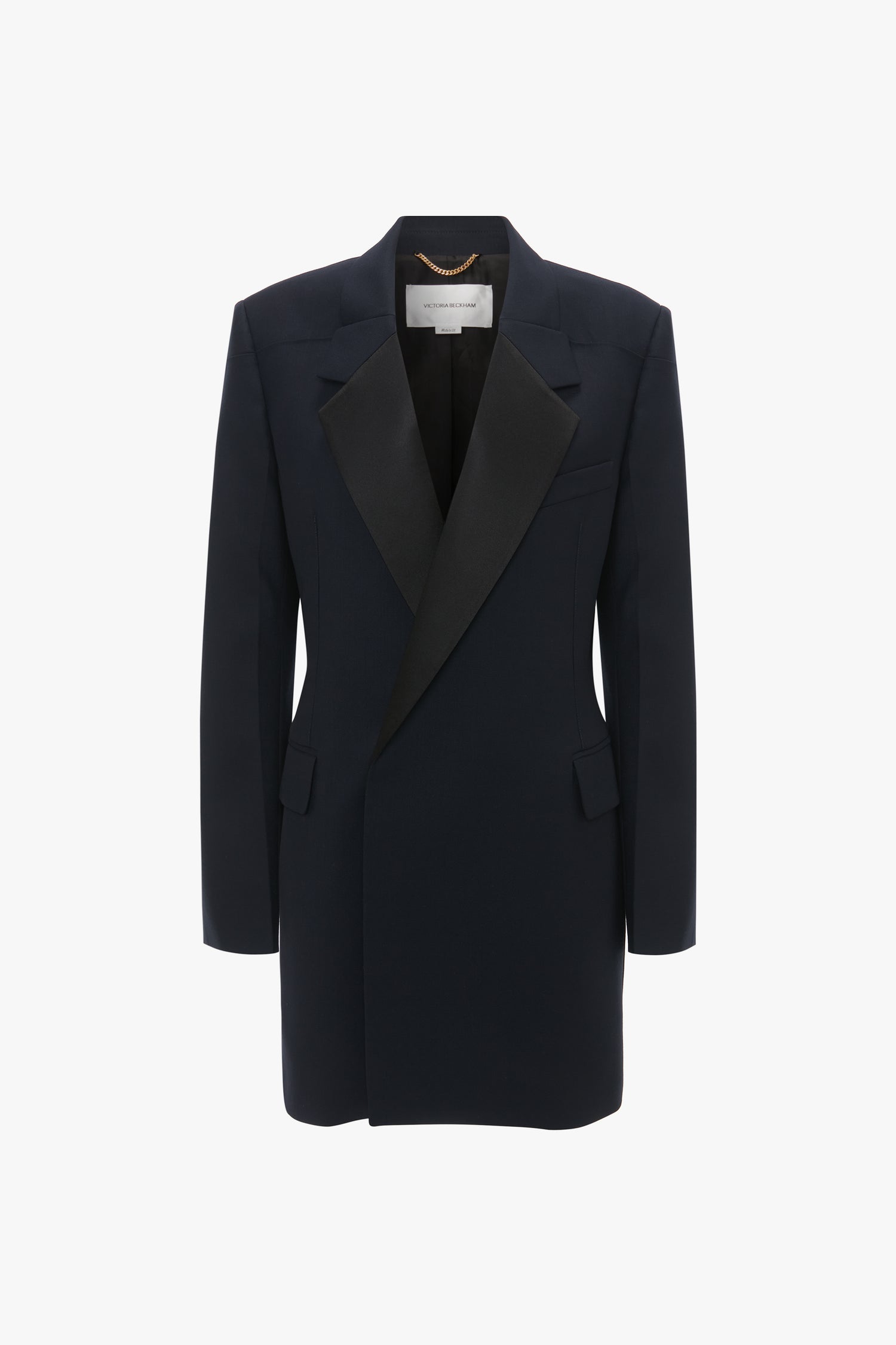 An Exclusive Fold Shoulder Detail Dress In Midnight by Victoria Beckham with a structured shoulder design, angled lapels, and flap pockets features a striking double-breasted cut against a white background.