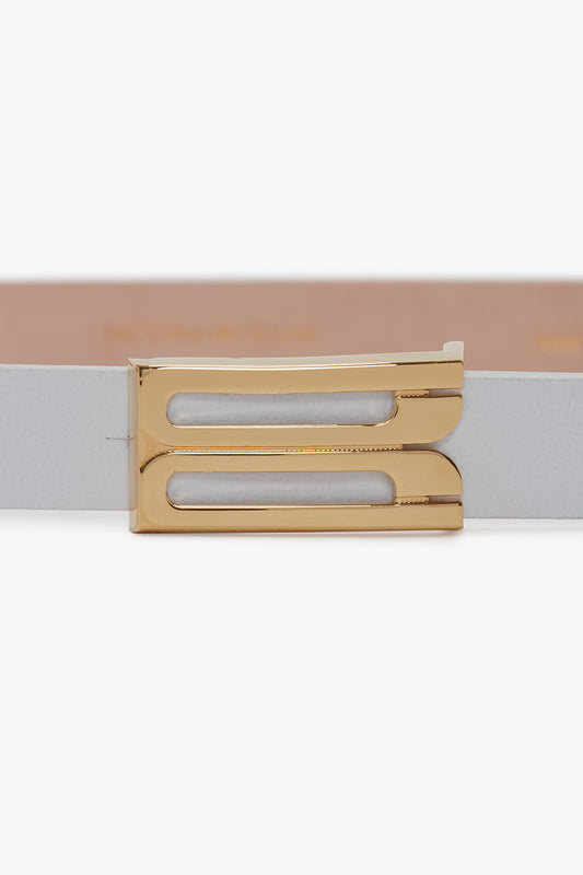 A close-up view of a Victoria Beckham Exclusive Micro Frame Belt In White Leather with a polished gold buckle.