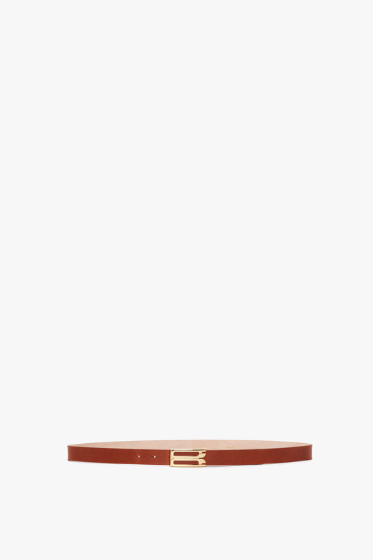 A brown calf leather Exclusive Frame Buckle Belt in Tan Leather by Victoria Beckham, centered and isolated on a white background.
