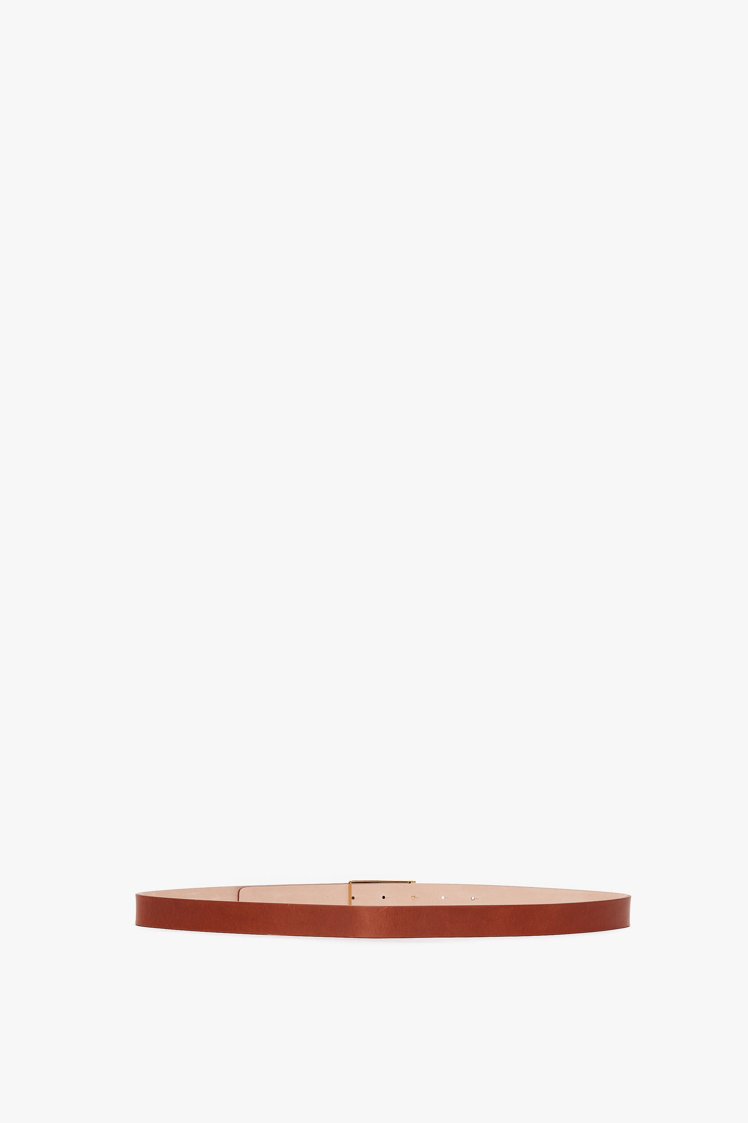 Exclusive Frame Buckle Belt in Tan Leather by Victoria Beckham, displayed horizontally against a white background.