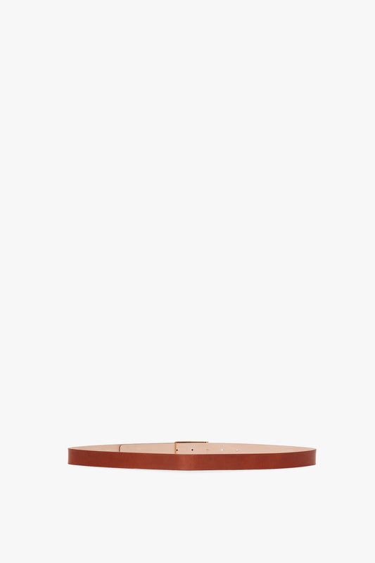 Exclusive Frame Buckle Belt in Tan Leather by Victoria Beckham, displayed horizontally against a white background.