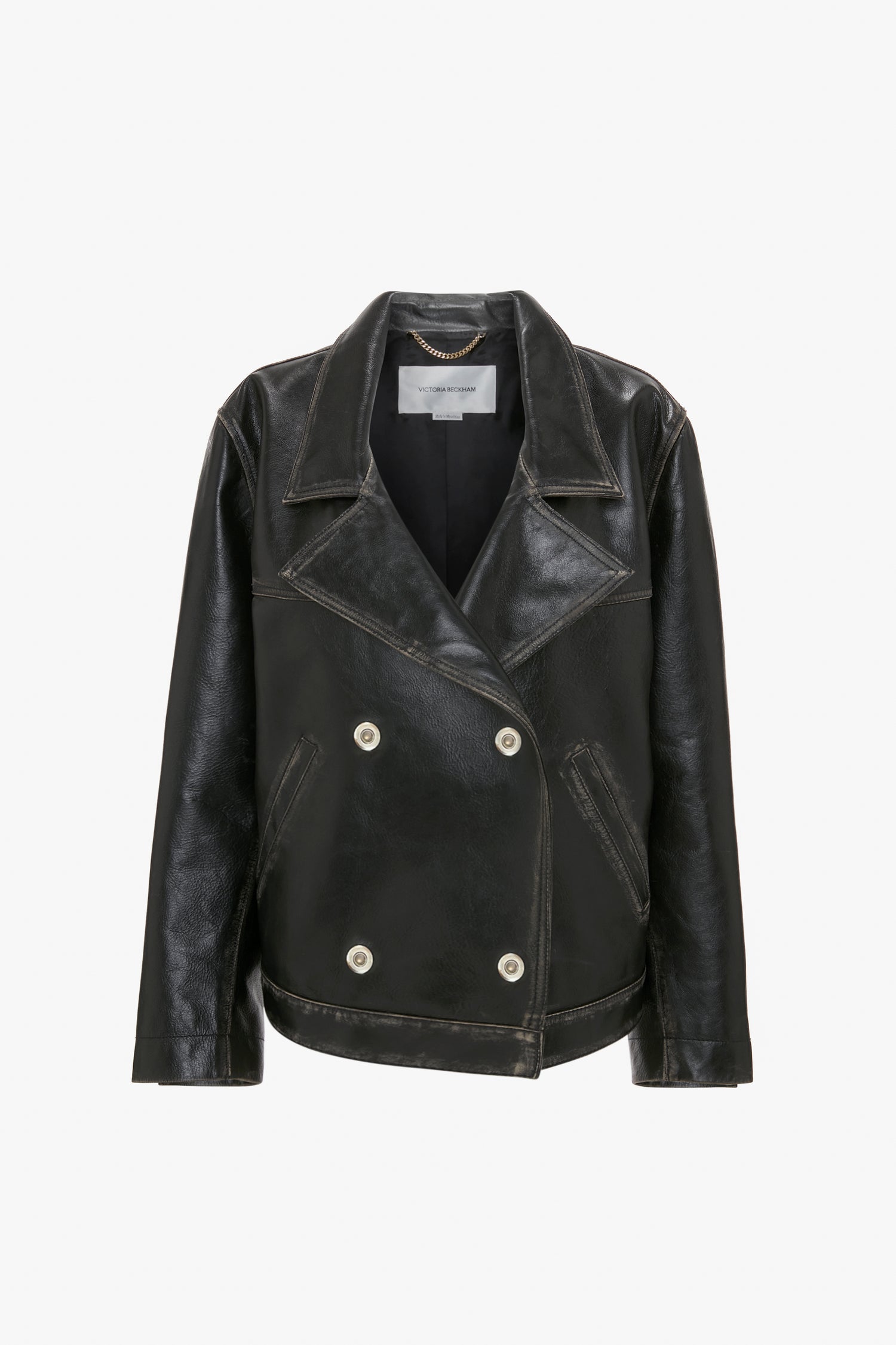 An Oversized Leather Jacket In Black by Victoria Beckham with a wide collar and white buttons, featuring an oversized biker-style design.
