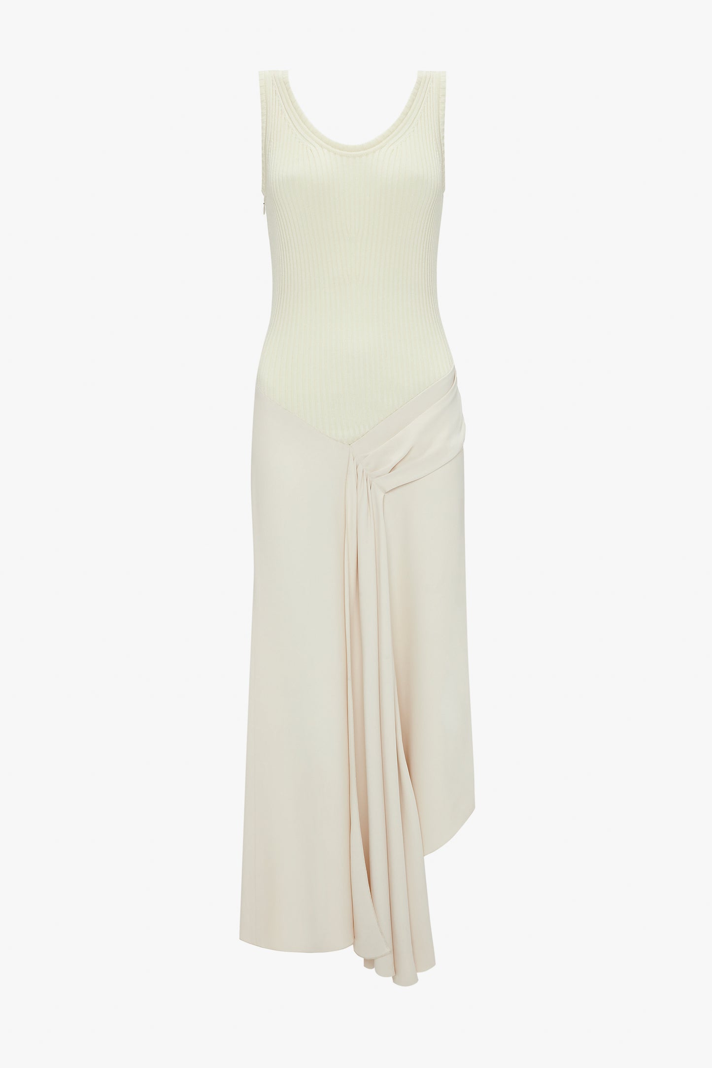 A Sleeveless Tie Detail Dress In Cream by Victoria Beckham, complete with a ribbed top and pleated draped detail on the left side of the skirt, has an asymmetric hemline for a modern twist.