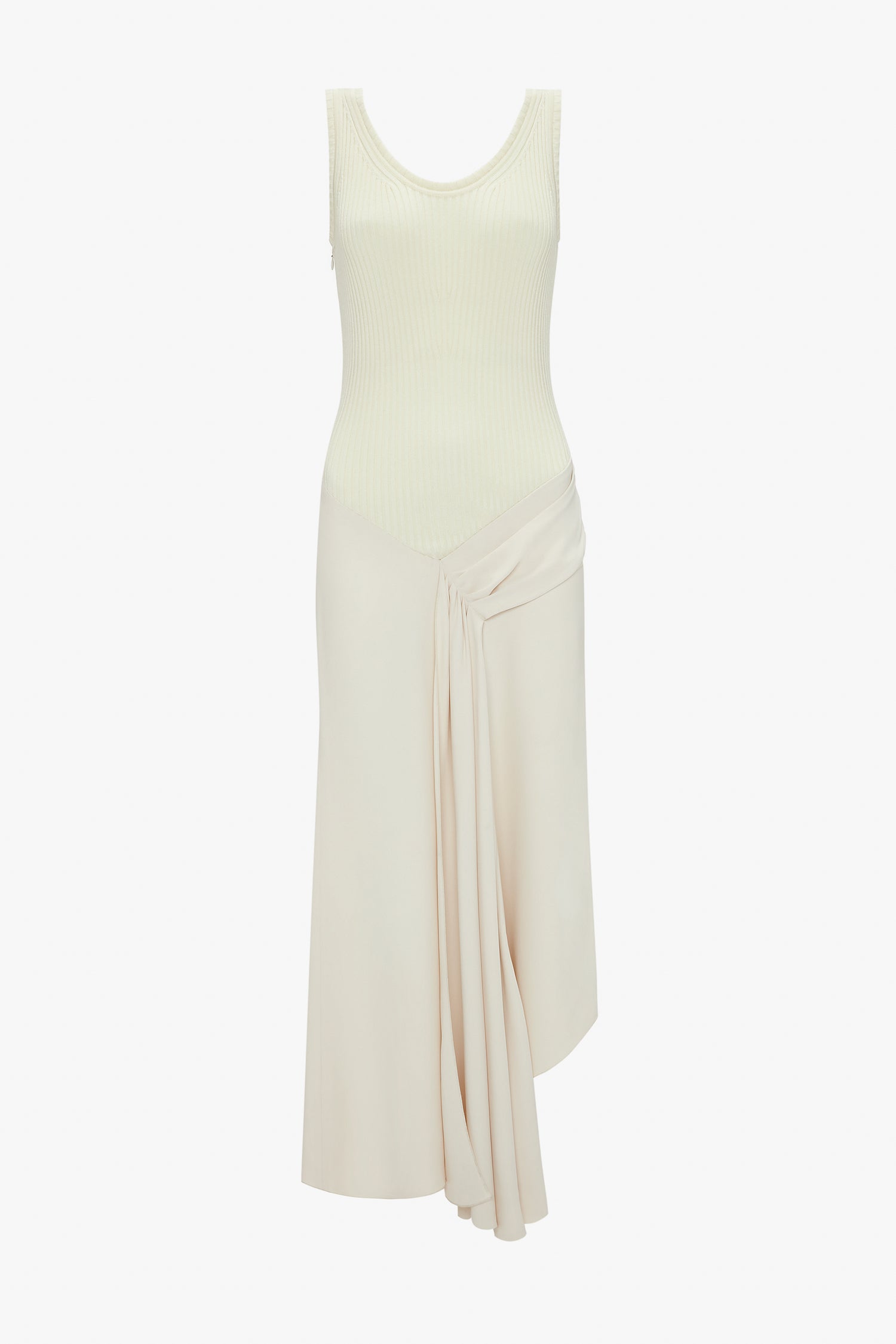 A Sleeveless Tie Detail Dress In Cream by Victoria Beckham, complete with a ribbed top and pleated draped detail on the left side of the skirt, has an asymmetric hemline for a modern twist.