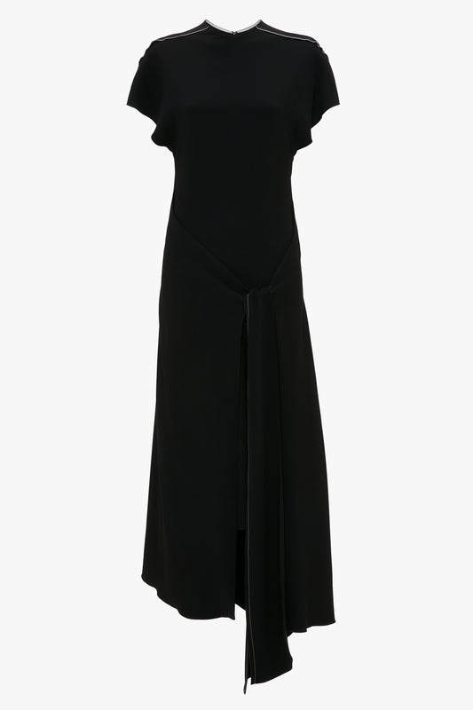 A black midi wrap dress with short sleeves and a front-tie detail at the waist, displayed against a white background, Victoria Beckham Short Sleeve Tie Detail Dress In Black.