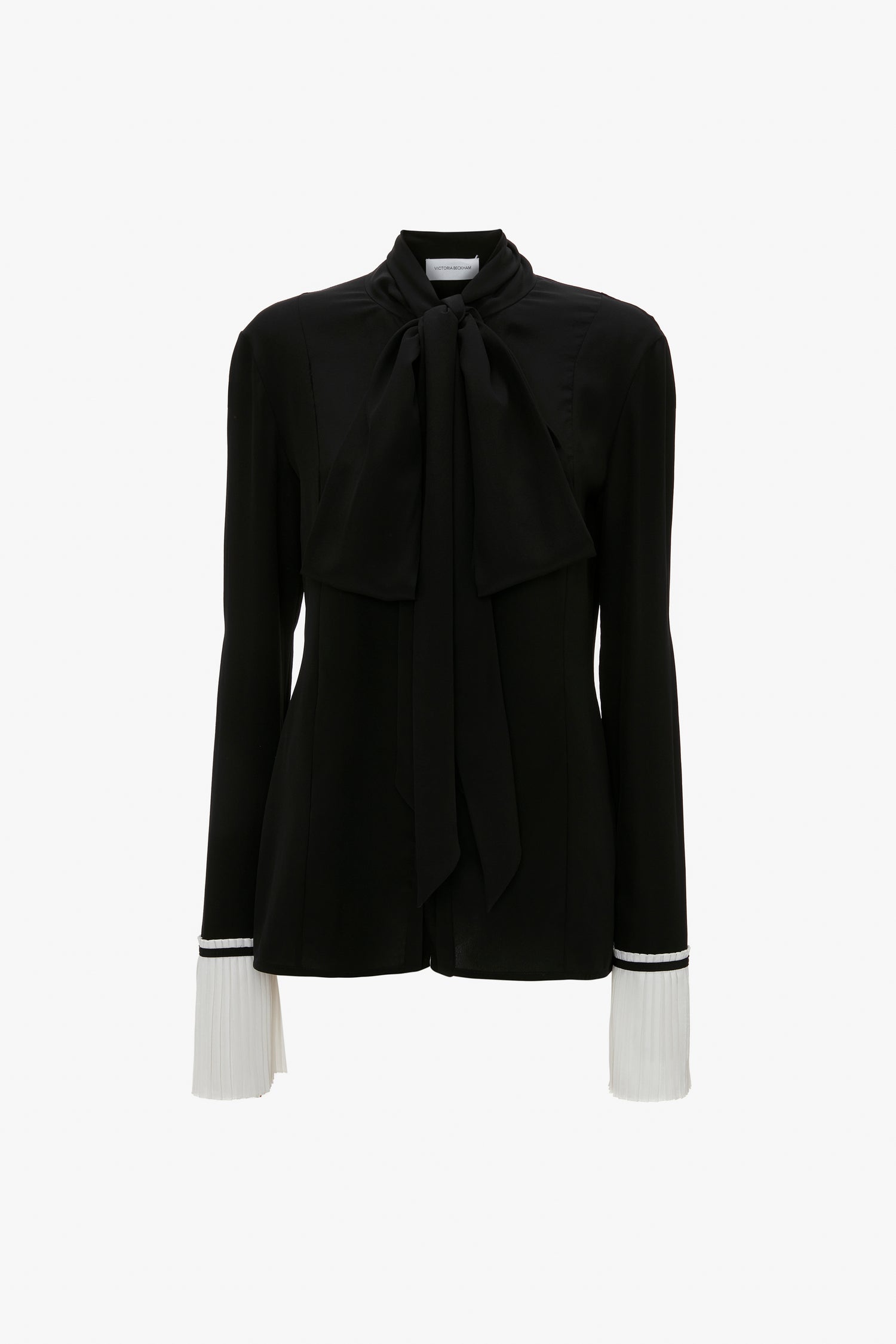 A Pleat Cuff Blouse In Black by Victoria Beckham featuring a large front bow and white knife pleat cuffs for an elegant finish.
