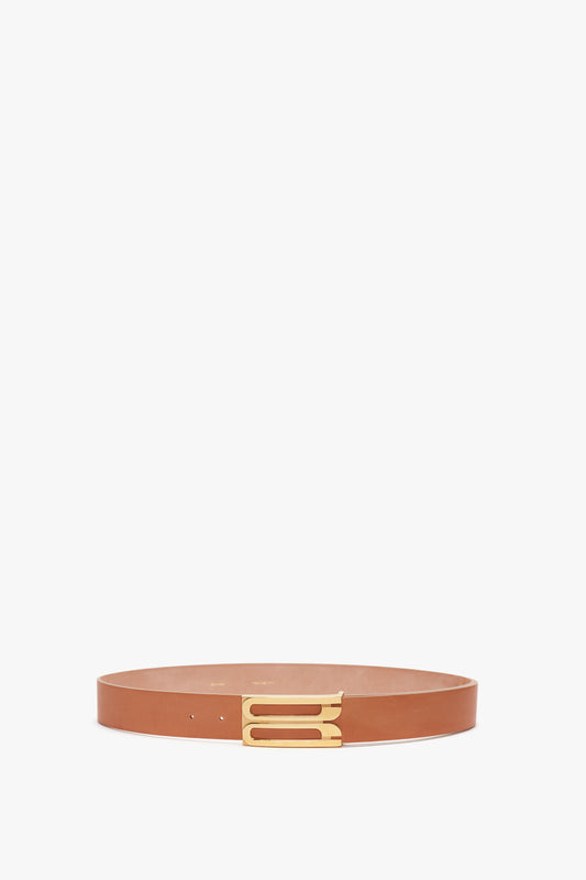 A Exclusive Jumbo Frame Belt In Nude Leather by Victoria Beckham, with a gold buckle, displayed on a white background.