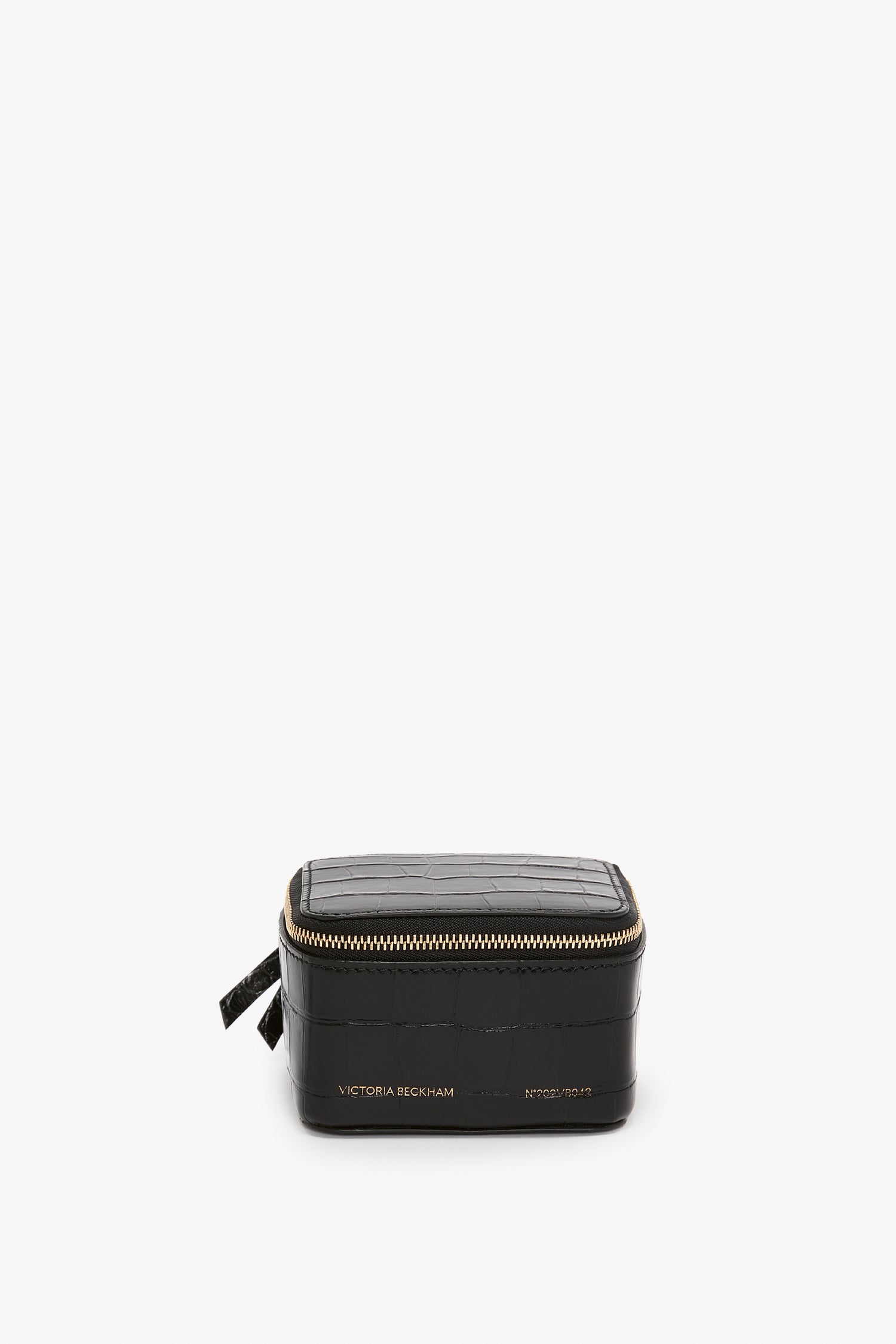A black rectangular zippered jewellery box with a Victoria Beckham label, embossed croc leather, isolated on a white background.