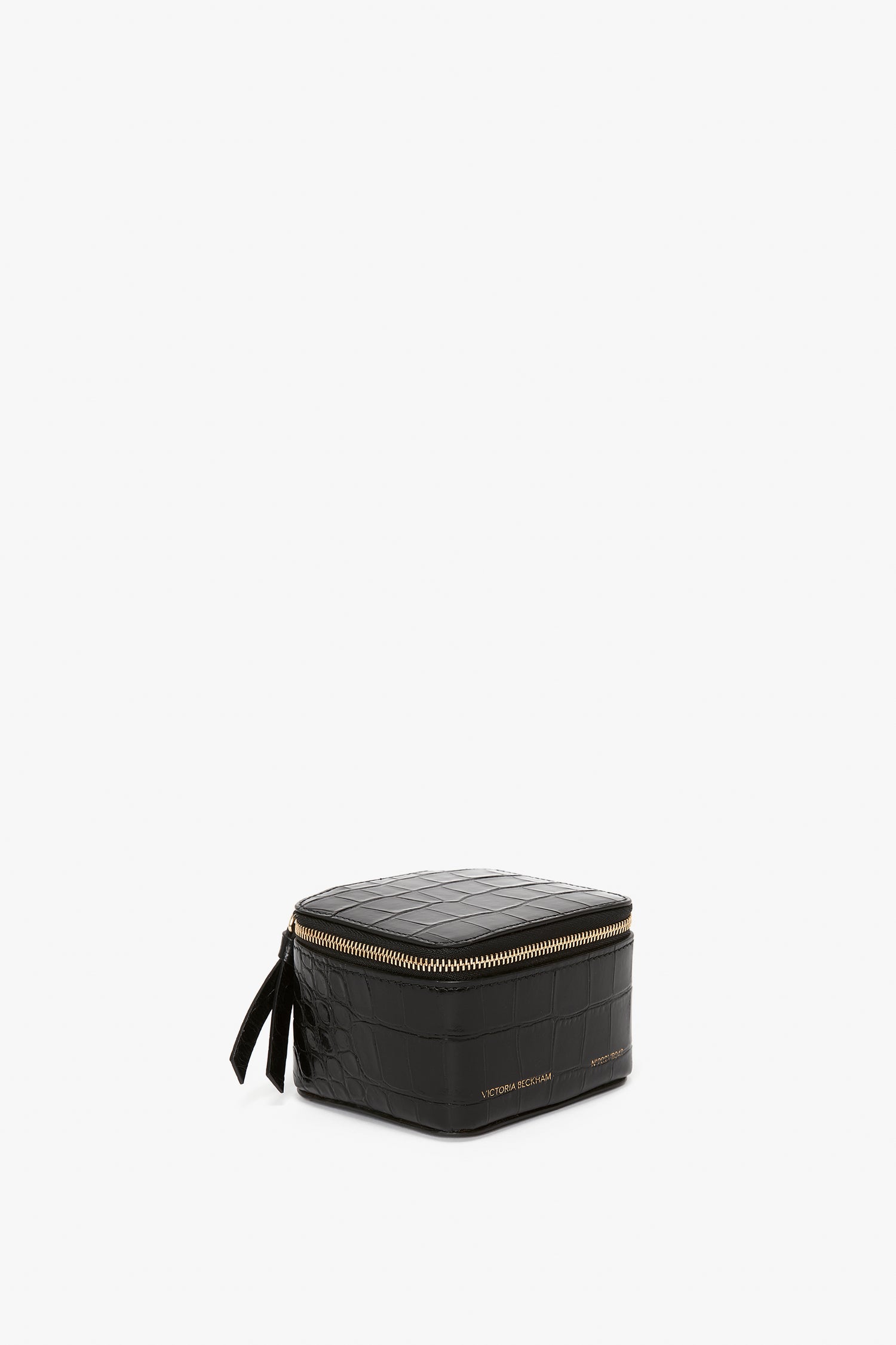 A Victoria Beckham Jewellery Box In Black Croc-Effect Leather with a gold-tone zip closure, isolated on a white background.
