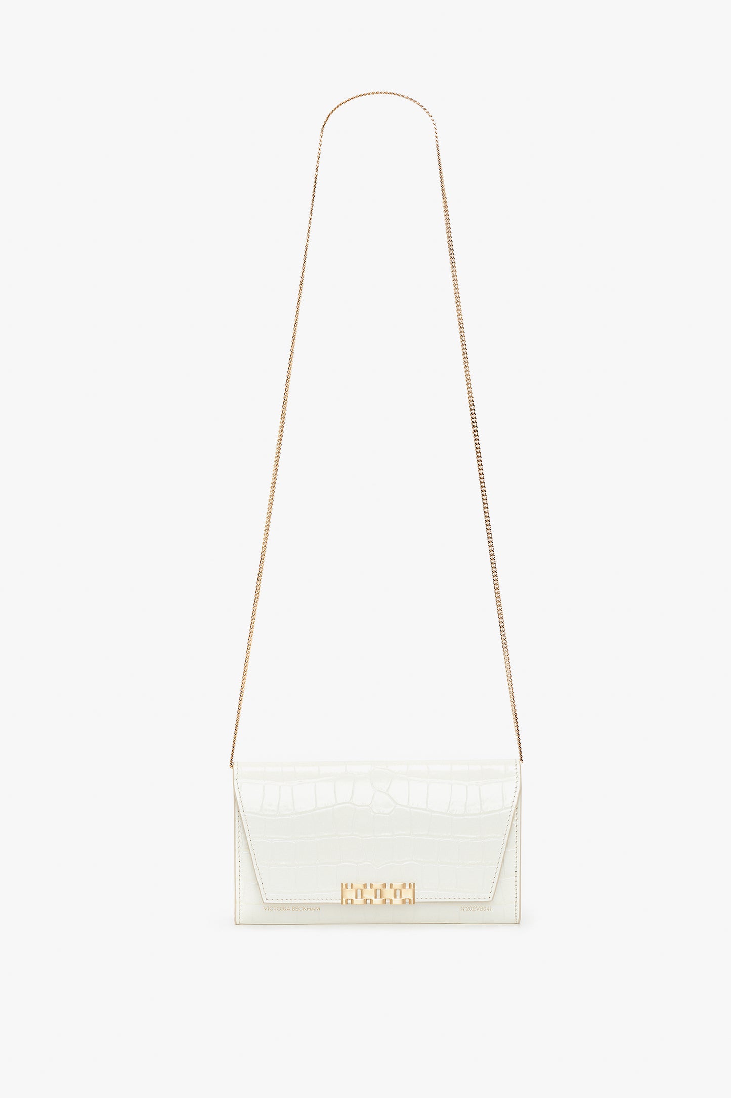 A Victoria Beckham Exclusive Wallet On Chain In Ivory Croc-Effect Leather, featuring a gold chain strap and a gold clasp on the front, is displayed against a white background.