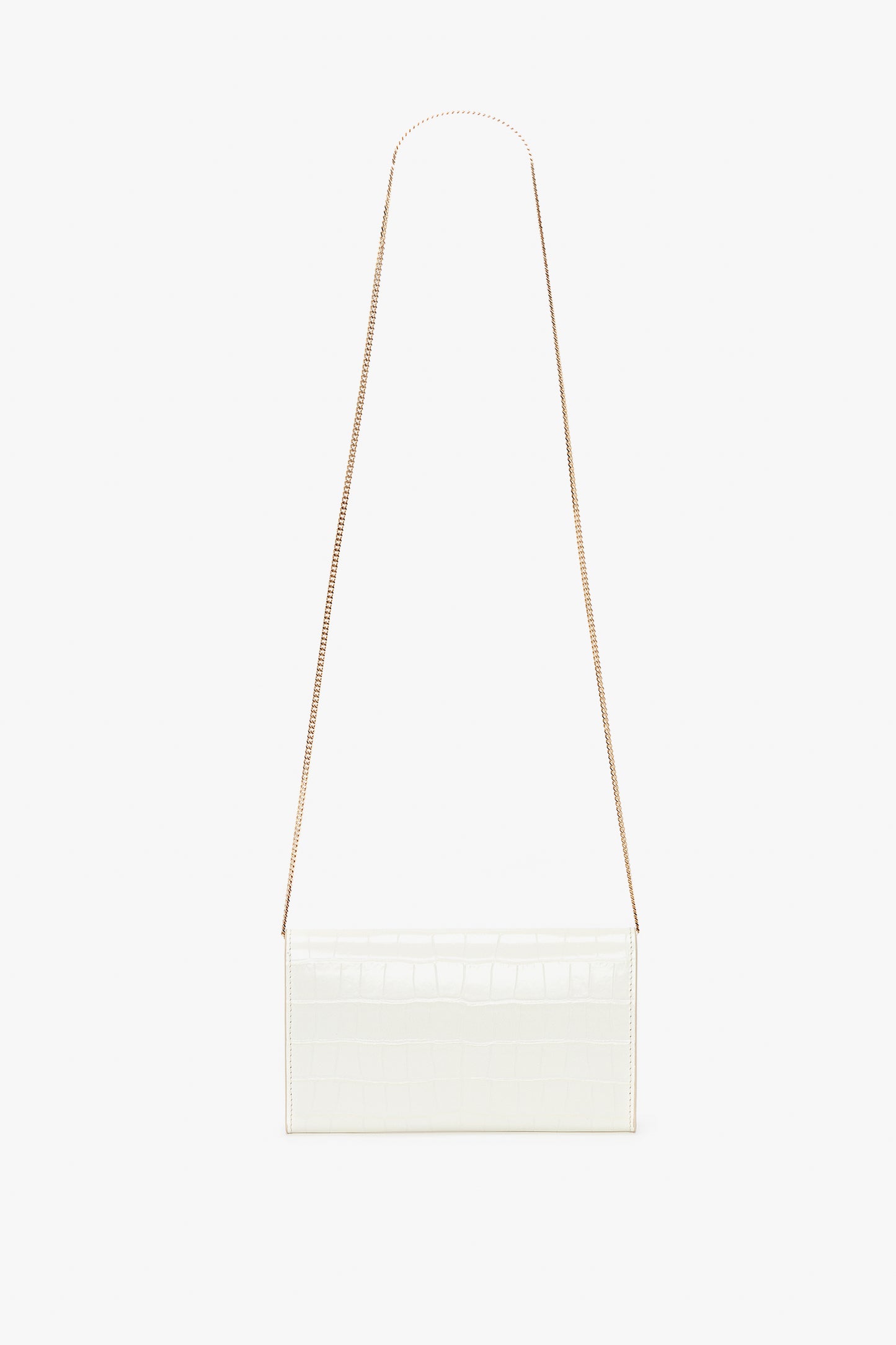 Victoria Beckham Exclusive Wallet On Chain In Ivory Croc-Effect Leather with a thin gold chain strap against a white background.