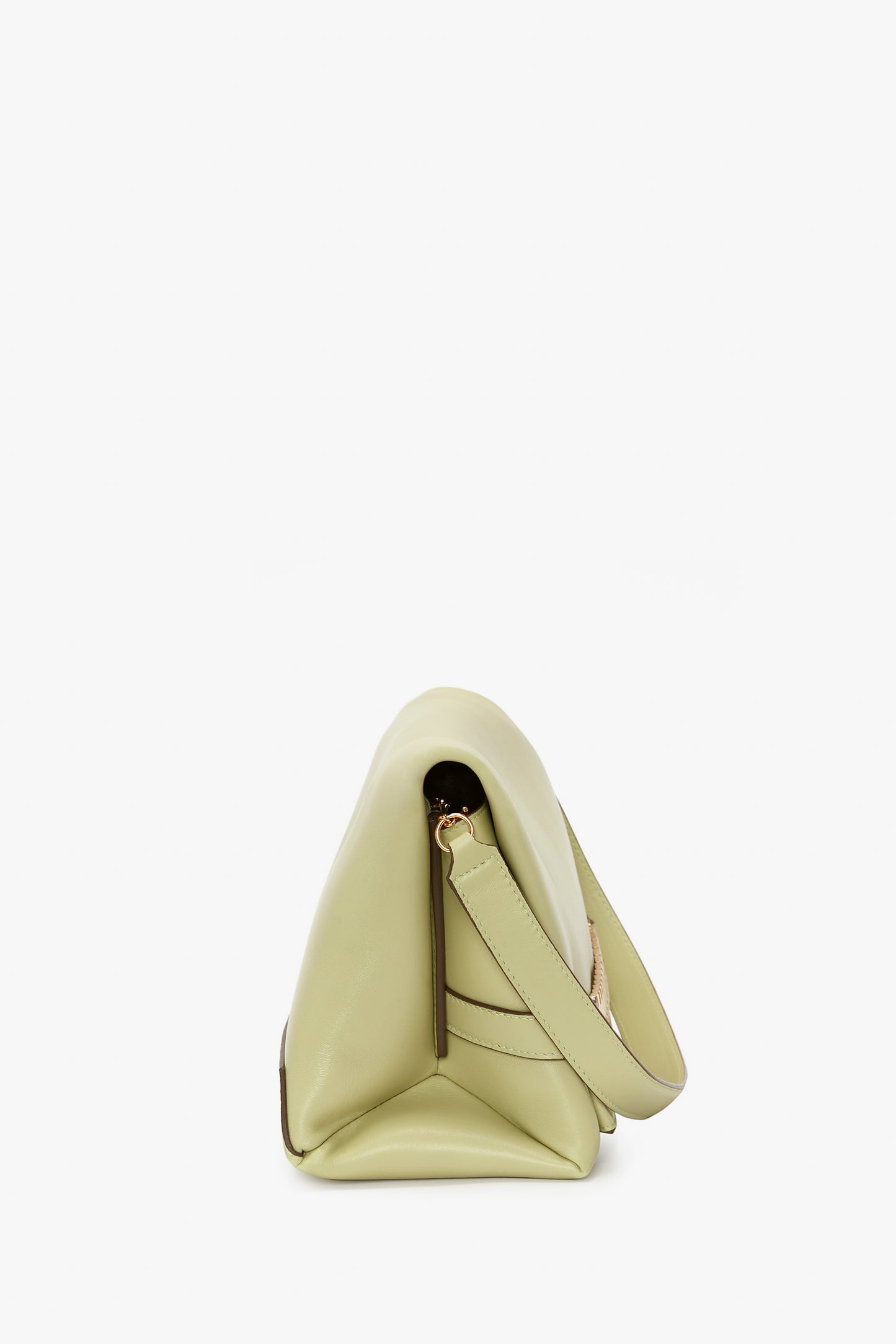 Side view of a light green, triangle-shaped handbag with a top handle and a minimalist design, reminiscent of the Chain Pouch Bag With Strap In Avocado Leather found in Victoria Beckham's collections.