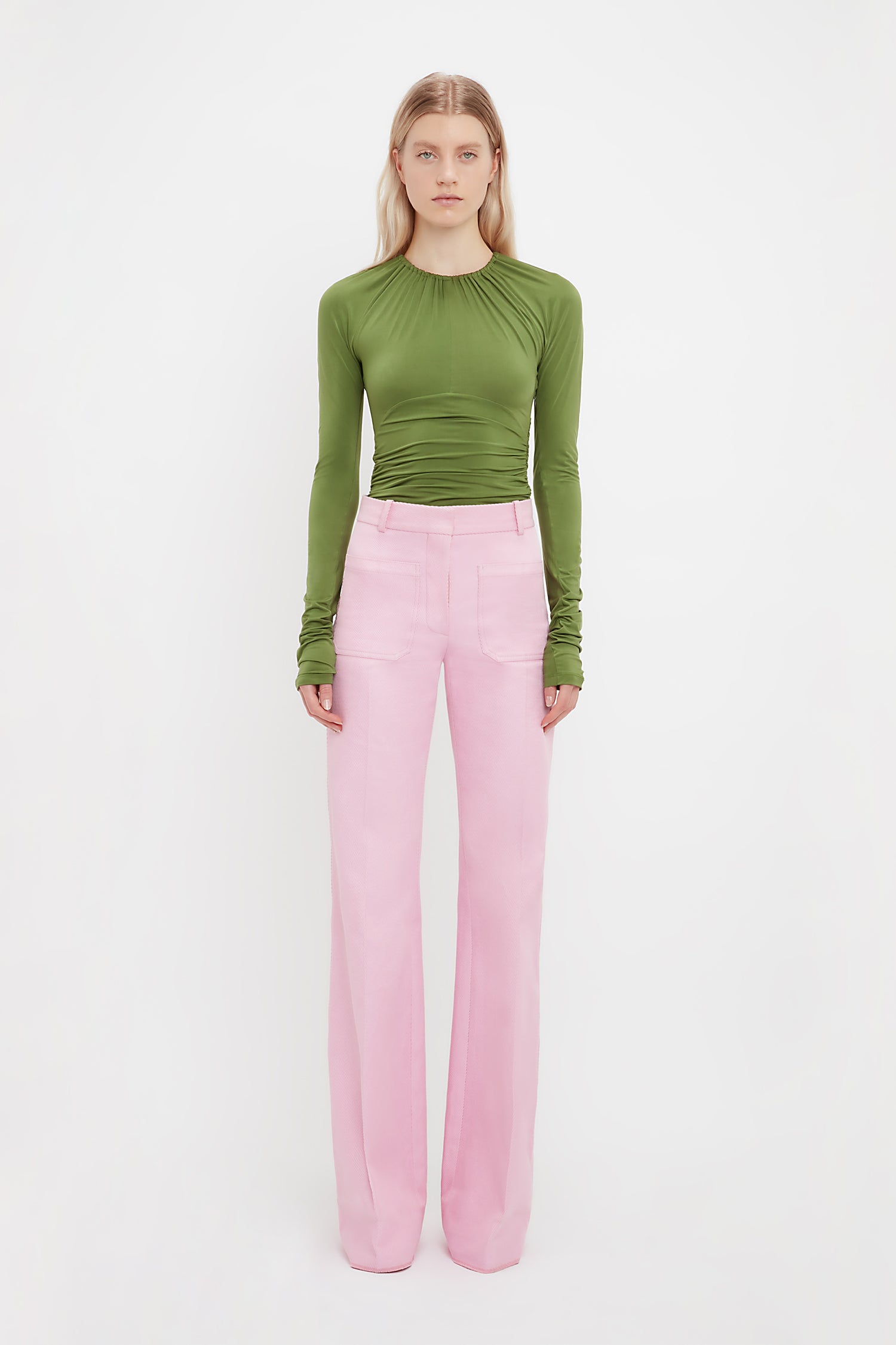 The bright pink bubblegum coloured Alina Trousers from designer Victoria Beckham. These tailored wide leg trousers come in a pink for a subtle yet standout look. Perfect trousers for workwear dressing or eveningwear.