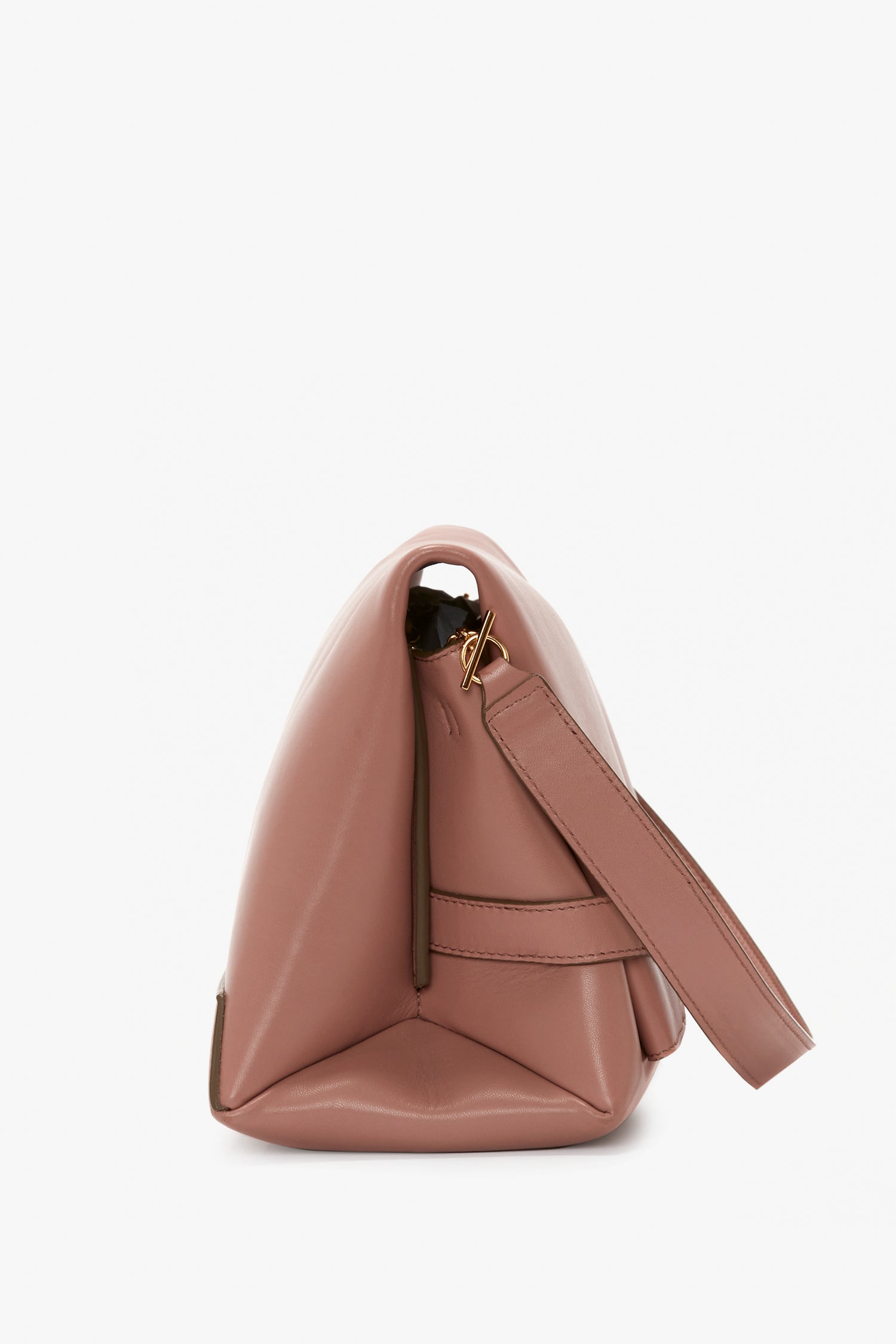 Side view of a light pink, rectangular handbag with a wide, removable strap and zipper closure—an everyday accessory that's both stylish and versatile. The Chain Pouch With Strap In Truffle Leather by Victoria Beckham.