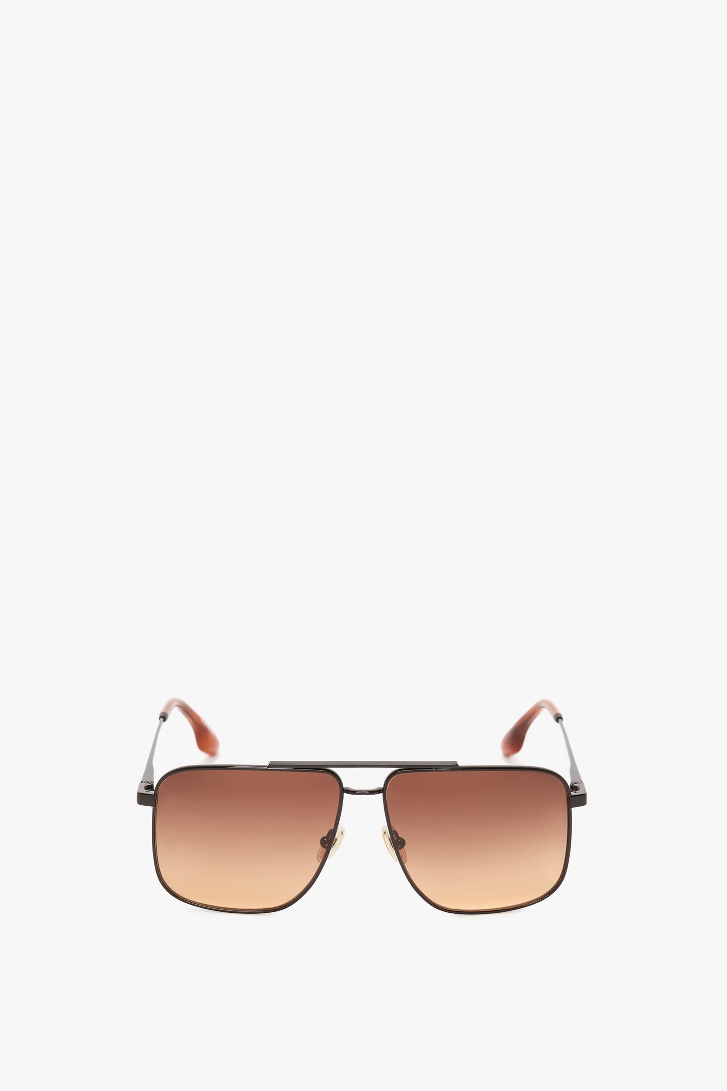 A pair of Double Bridge V-Line Navigator In Gold-Black-Brown sunglasses with a thin gold metal frame, blush lenses, and adjustable nose pads adorned with the Victoria Beckham logo.