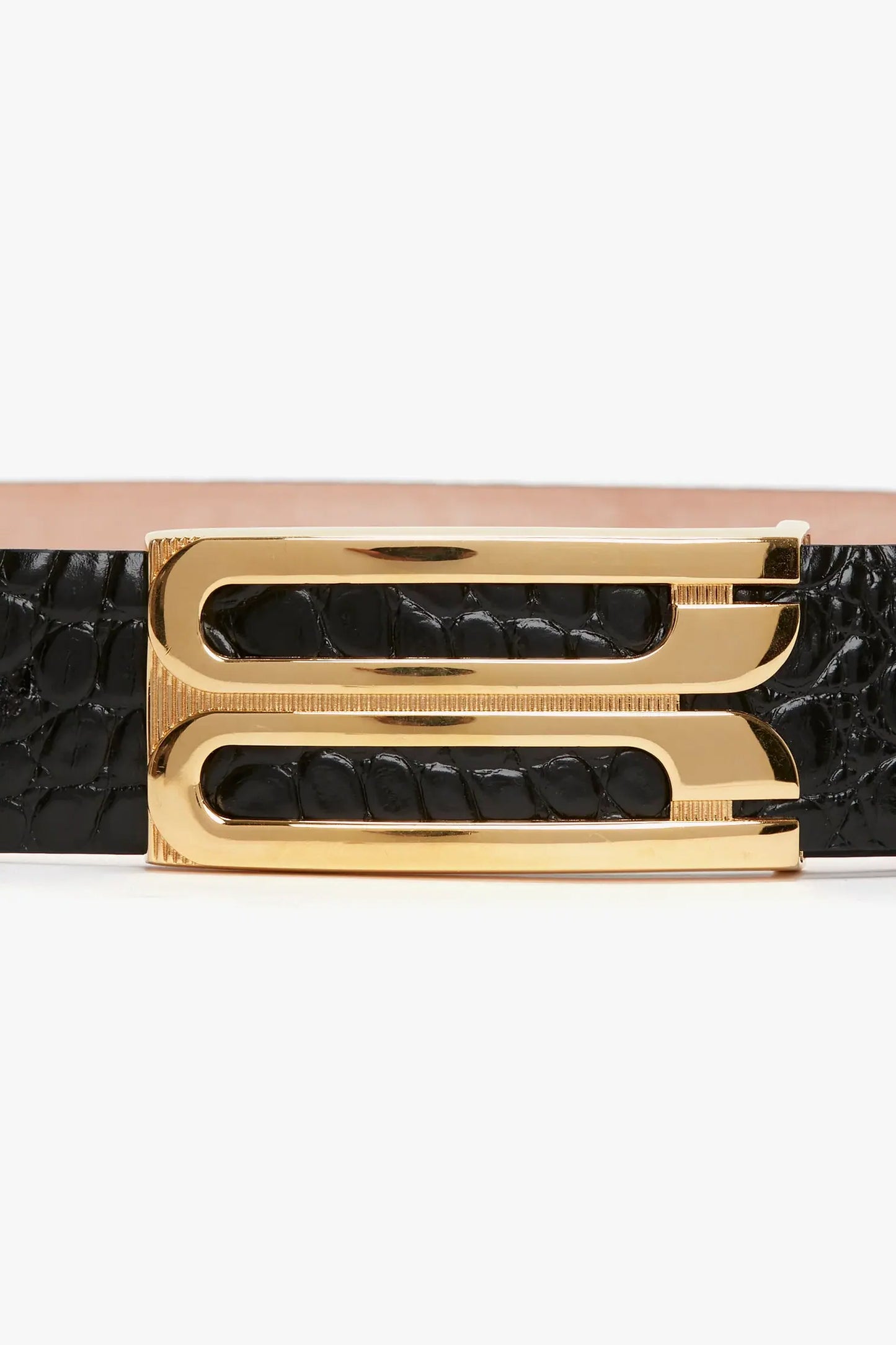 Close-up of a Victoria Beckham Jumbo Frame Belt In Black Croc-Effect Leather with a shiny gold buckle, isolated on a white background.