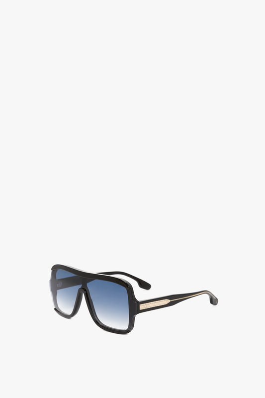 A pair of Victoria Beckham Layered Mask Sunglasses In Black Gradient with a thick frame, graduated black lenses, and metallic accents on the arms, against a plain white background.