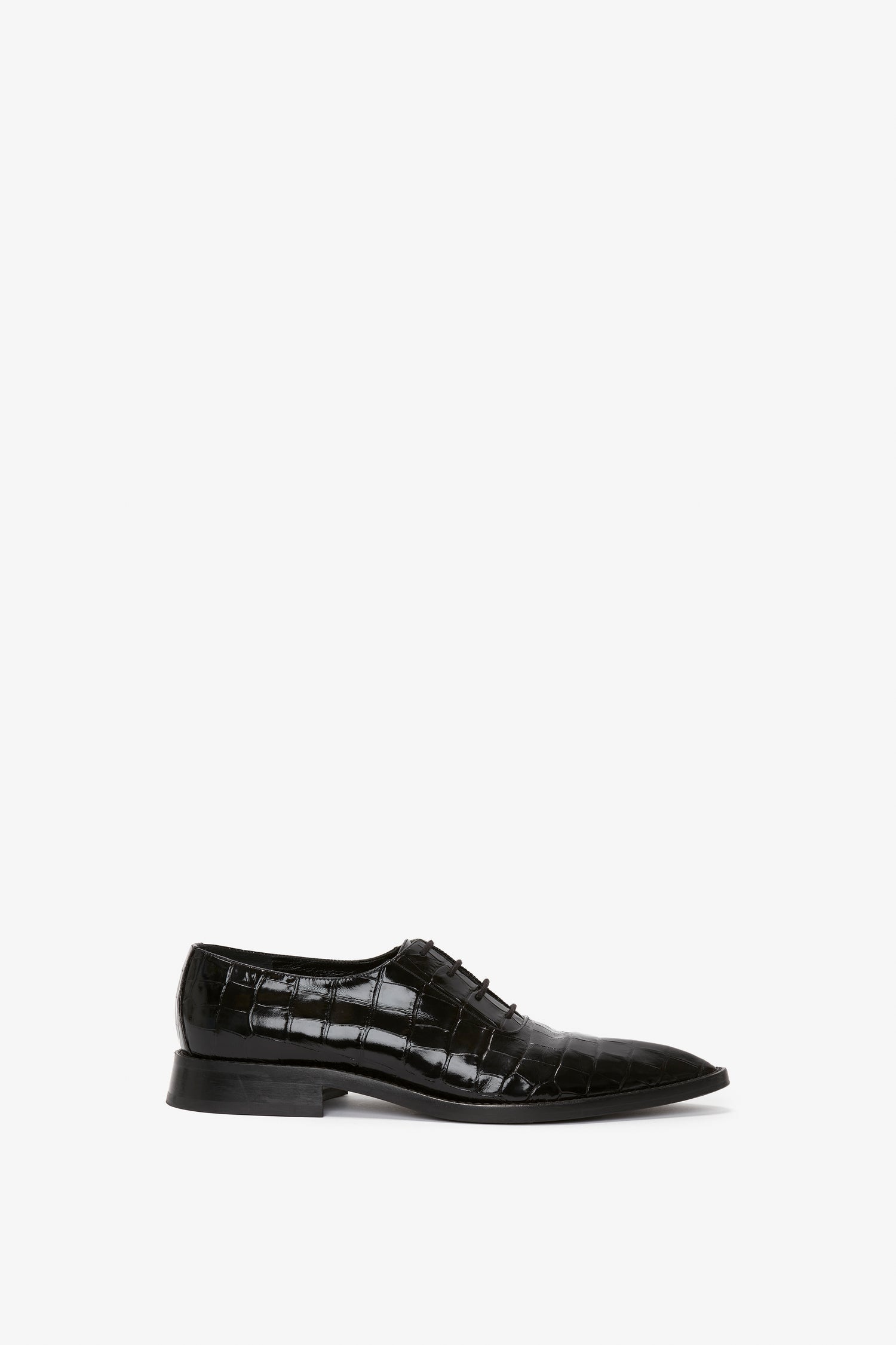 Victoria Beckham's Pointy Toe Flat Lace Up In Black Croc-Effect Leather with a polished finish and a lace-up design, featuring an embossed croc calf leather texture pattern, set against a plain white background.