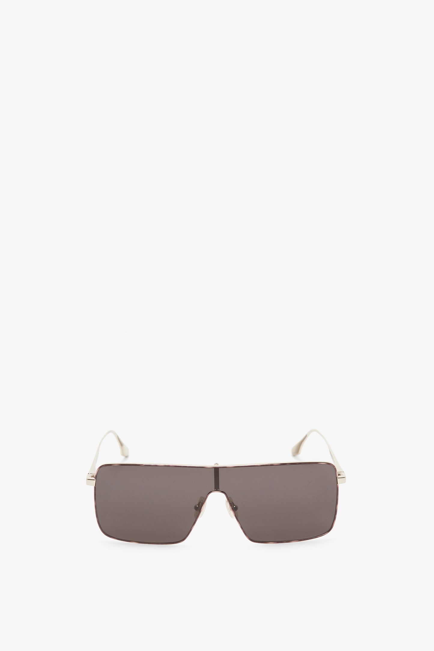 A pair of Rectangular Visor In Gold-Smoke sunglasses with dark lenses and white temples, featuring the Victoria Beckham logo on the sides, shown against a neutral background.