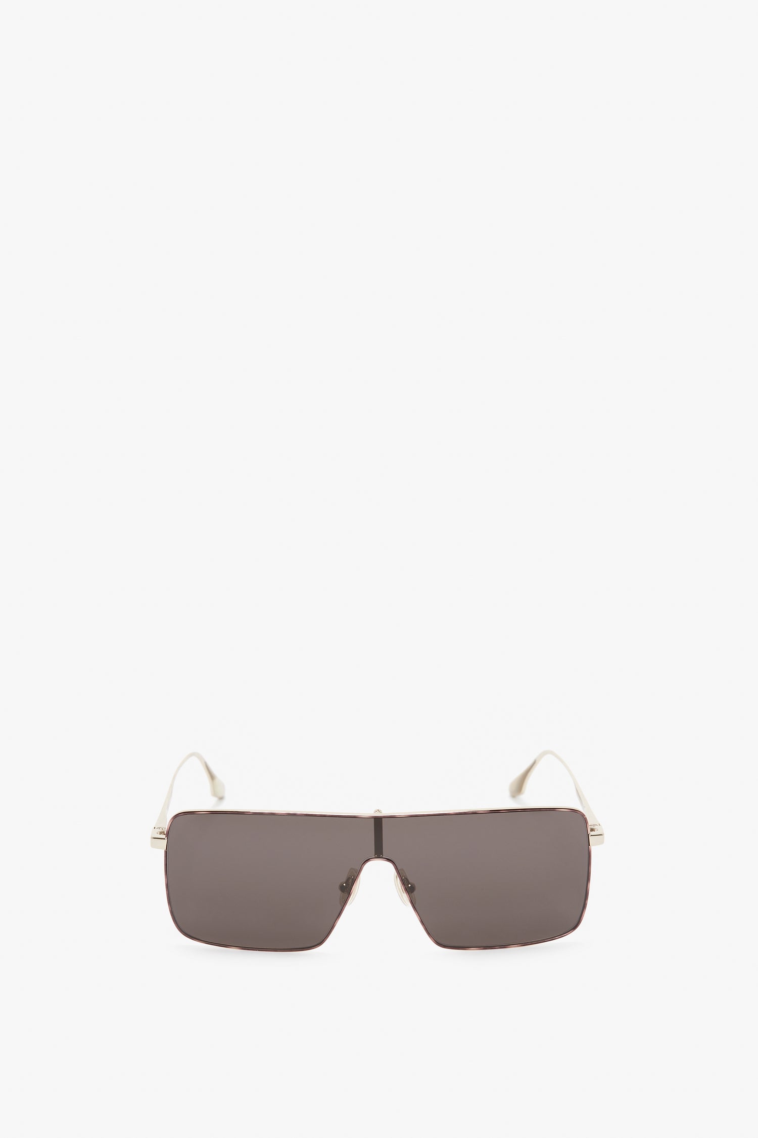 A pair of Rectangular Visor In Gold-Smoke sunglasses with dark lenses and white temples, featuring the Victoria Beckham logo on the sides, shown against a neutral background.