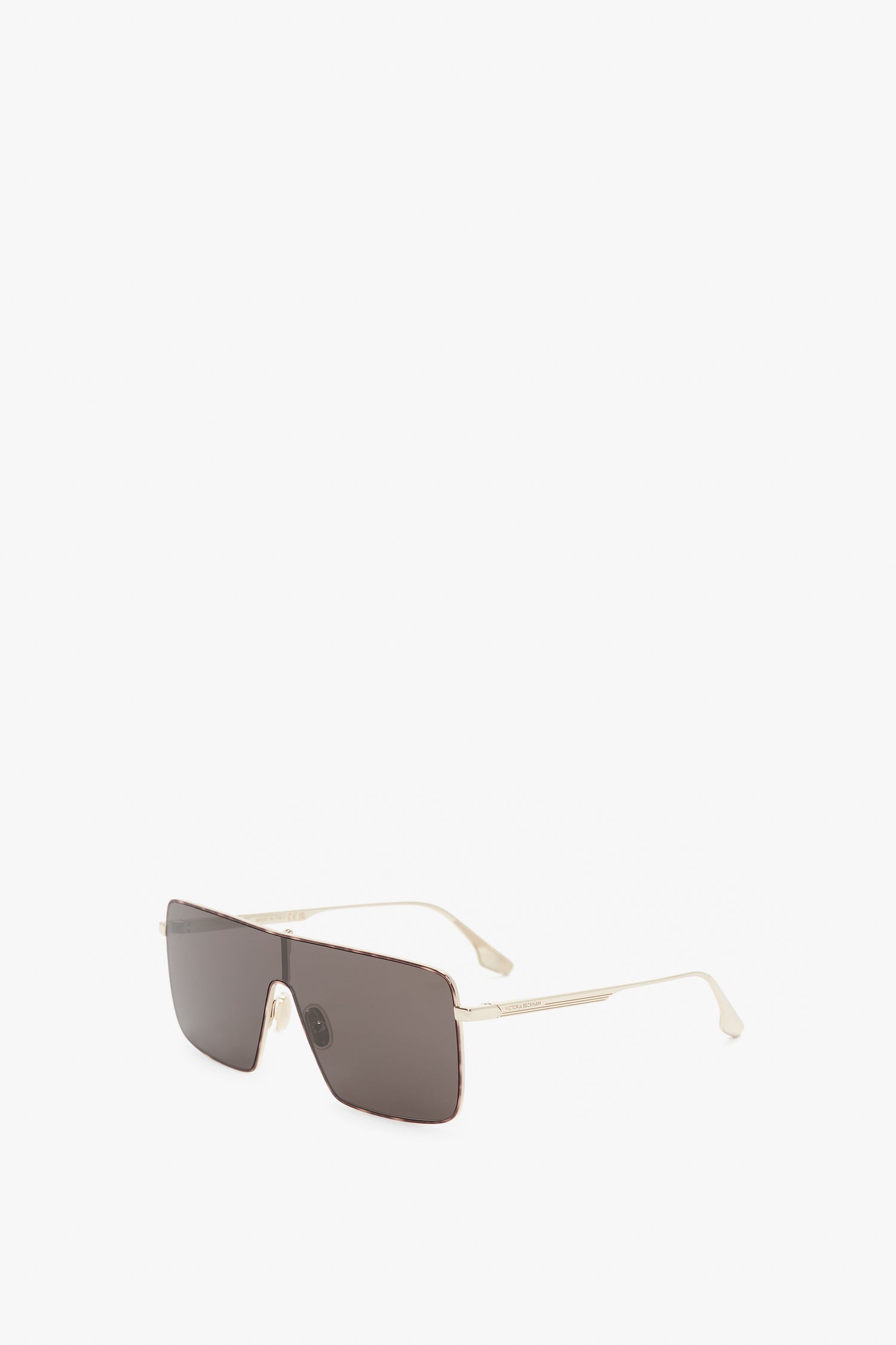 A pair of Rectangular Visor In Gold-Smoke sunglasses with thin gold frames and light-colored temple tips, featuring the Victoria Beckham logo, displayed on a plain white background.