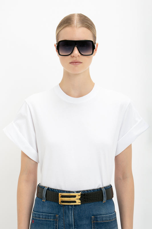 A woman wearing sunglasses and a Victoria Beckham Asymmetric Relaxed Fit T-shirt in White.