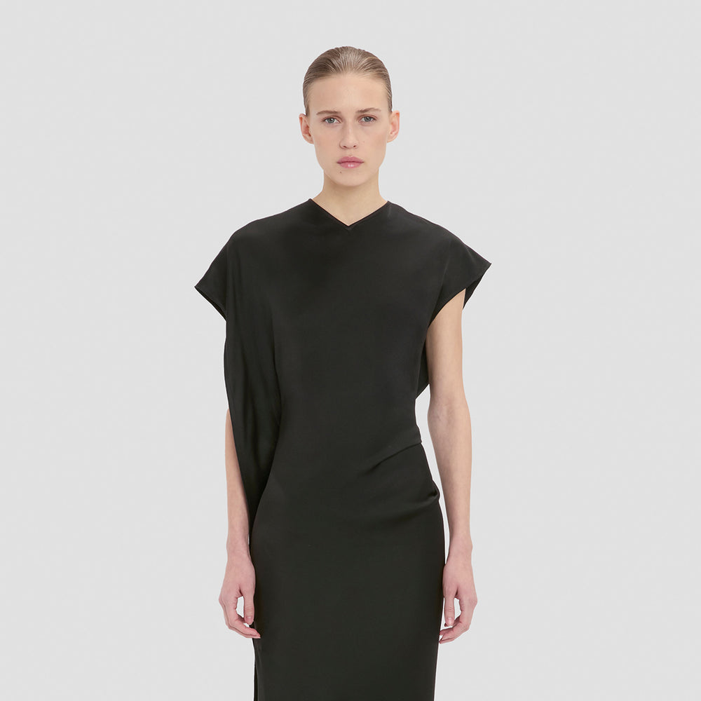 victoria beckham black dress stuns in a sleek with a daring thigh-high slit in London Winter 2025 collection Did Victoria Beckham just steal