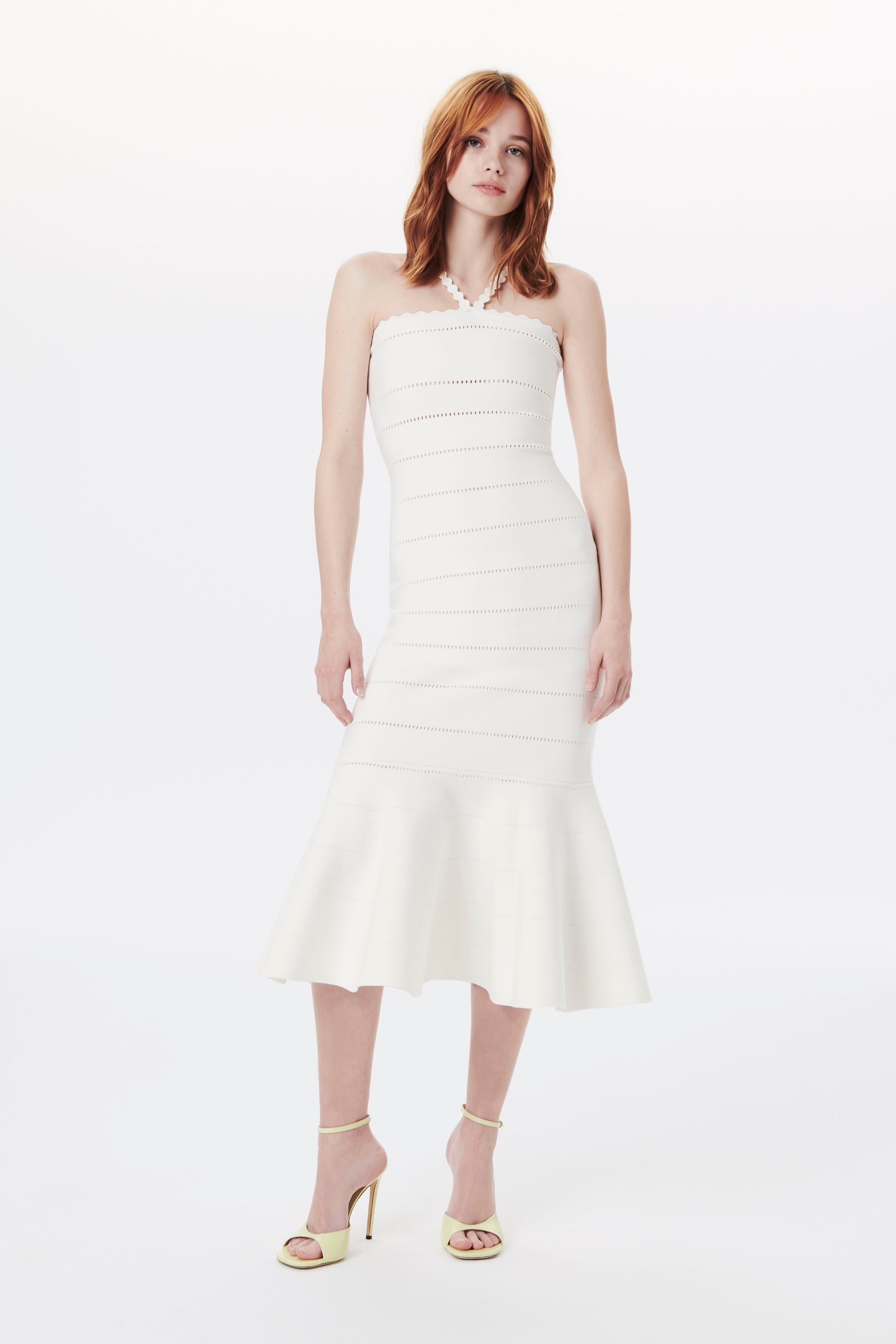 The Scalloped Strap Flare Dress in white from Victoria Beckham is made from compact viscose fabrics which was crafted to a body-con design with flounced hem for a feminine dress look.