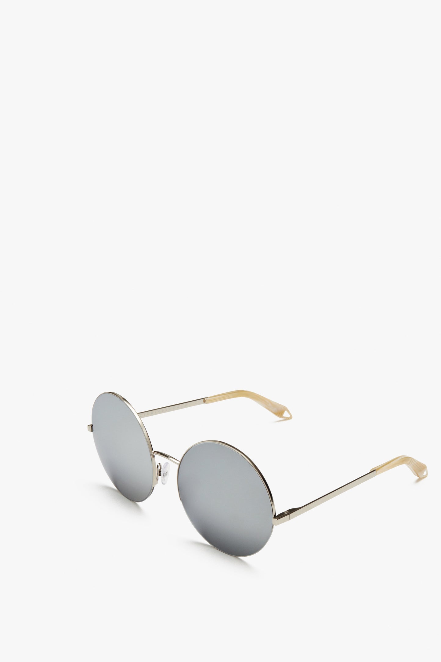 A pair of Supra Round sunglasses by Victoria Beckham with silver frames and light brown temple tips, featuring Zeiss certified lenses for superior UV protection, displayed on a white background.