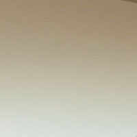 Close-up of a smooth, light beige surface with a slightly darker edge in the top right corner, reminiscent of the sleek and modern finish found in Victoria Beckham's Brow Aviator Sunglasses In Azure.