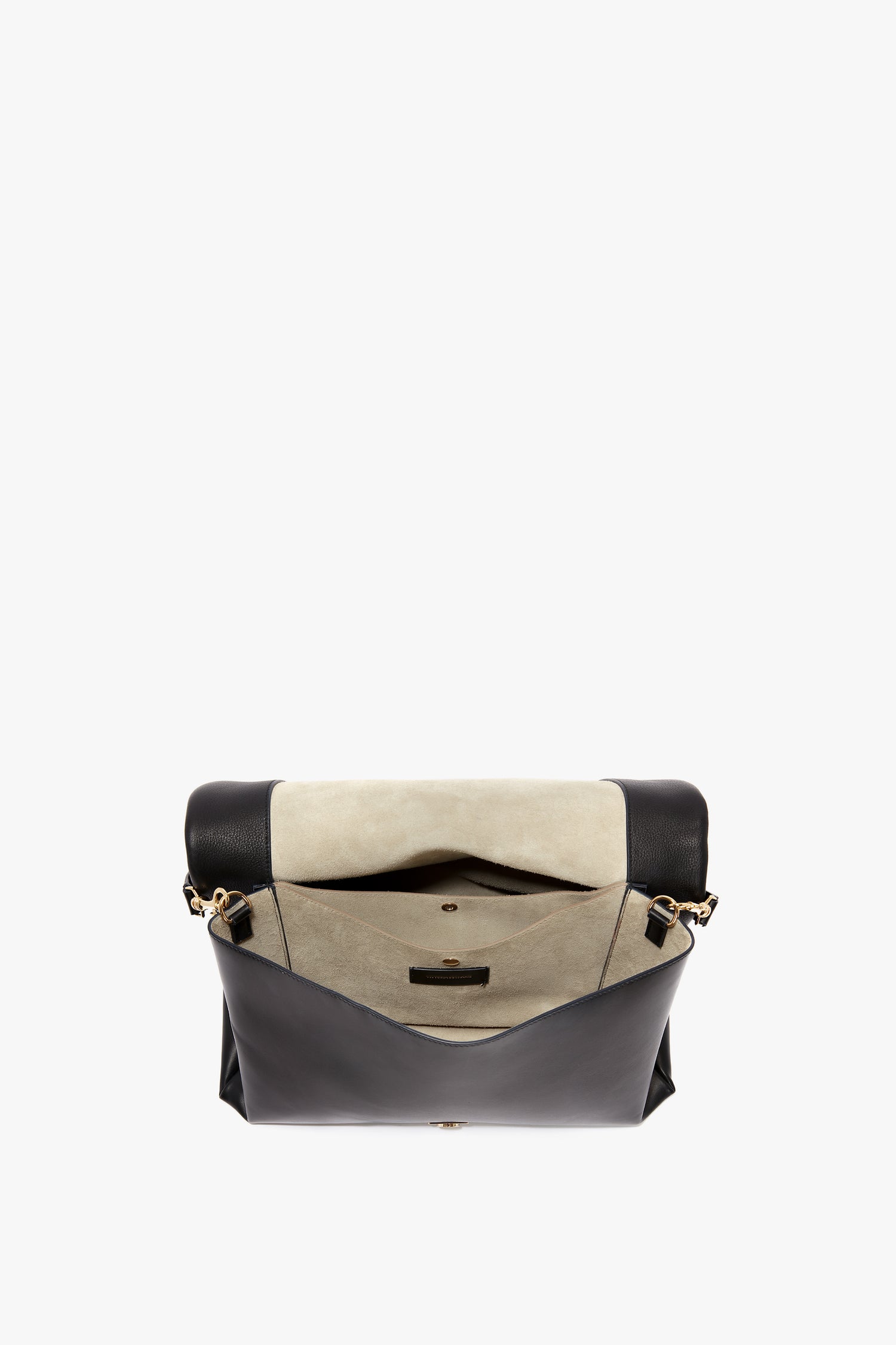 Jumbo Chain Pouch Bag In Black Leather by Victoria Beckham with beige suede interior, showing open flap revealing compartments, a zippered pocket, and a small leather tag. The bag features a detachable strap for versatility and style.